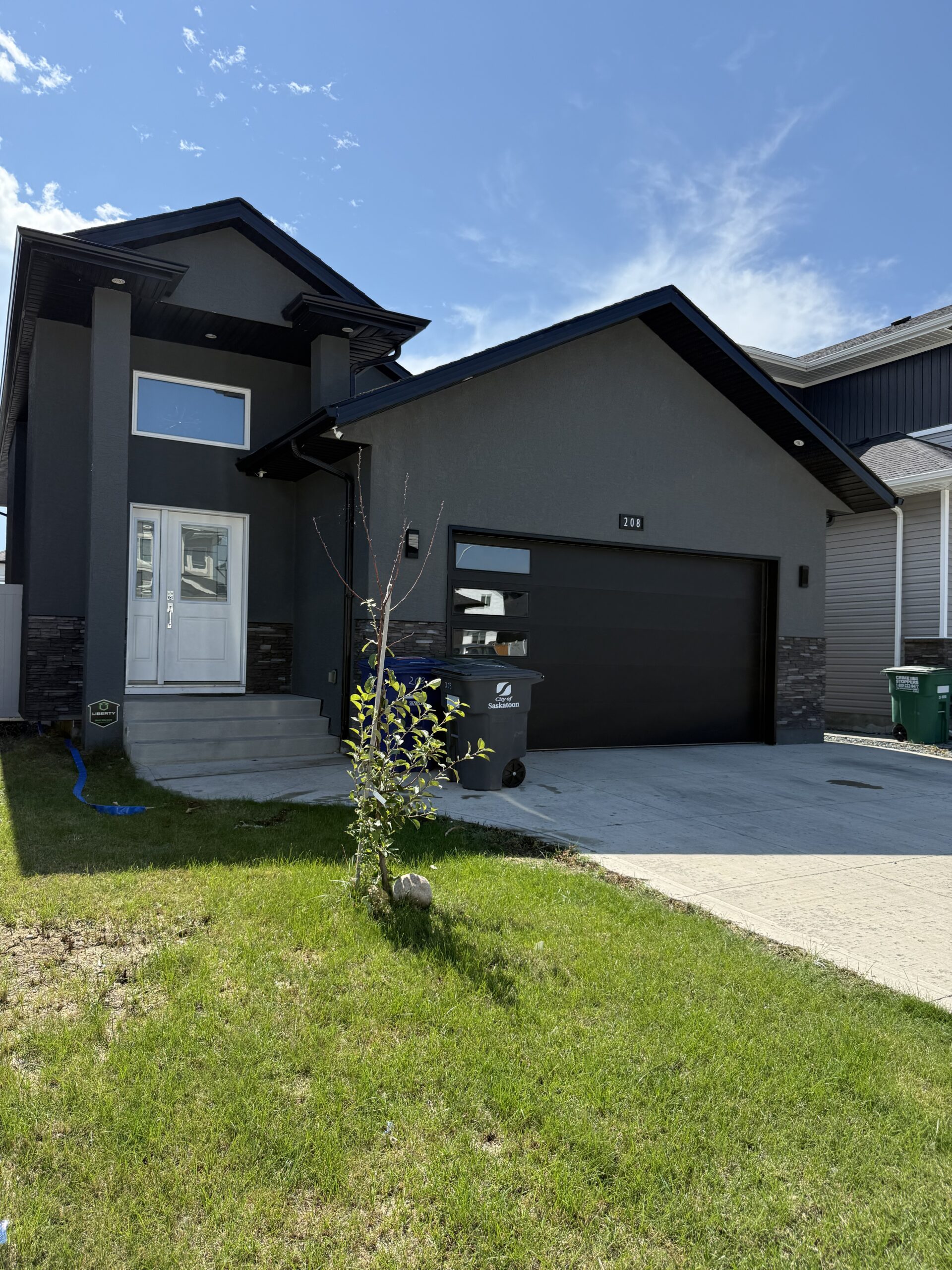 Modern 4-bedroom home in Aspen Ridge with landscaped yard, deck, patio, and bright open-concept living space